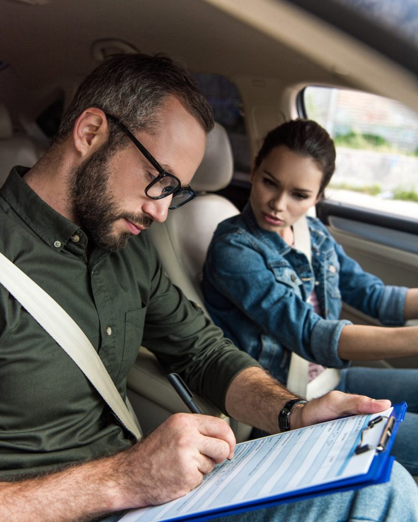 teacher-writing-something-to-clipboard-during-driving-test.jpg teacher-writing-something-to-clipboard-during-driving-test.jpg